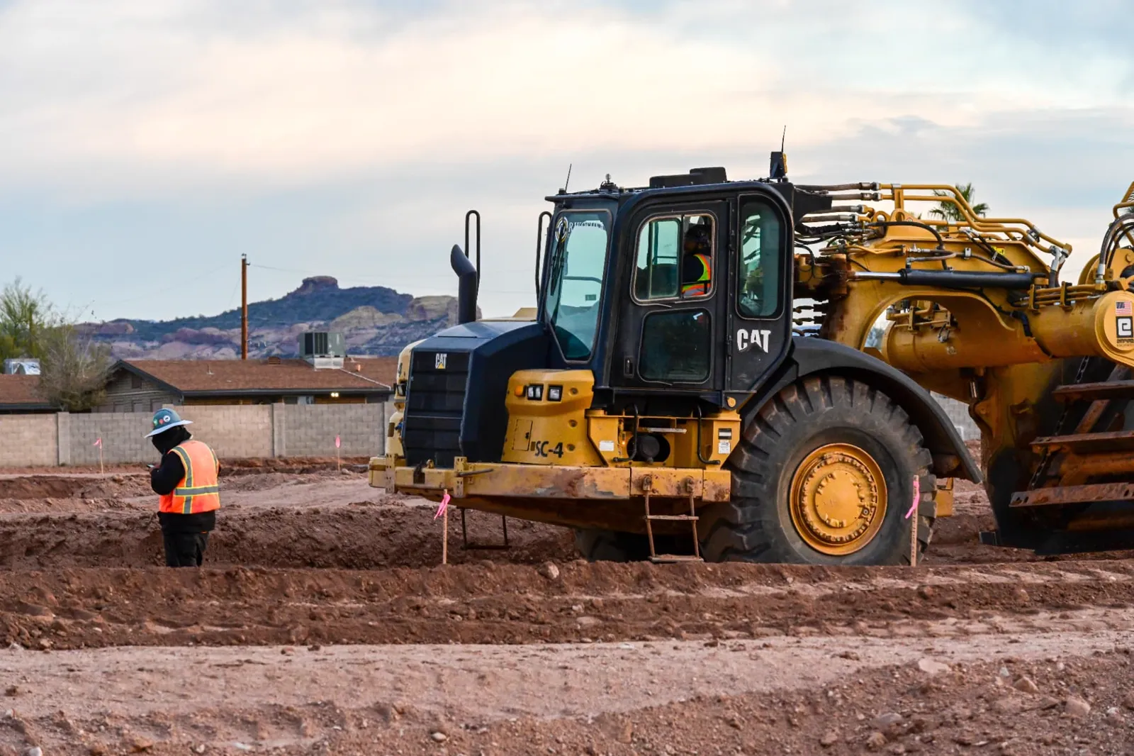 Residential development grading with a Caterpillar scraper on a subdivision pad in Phoenix, AZ