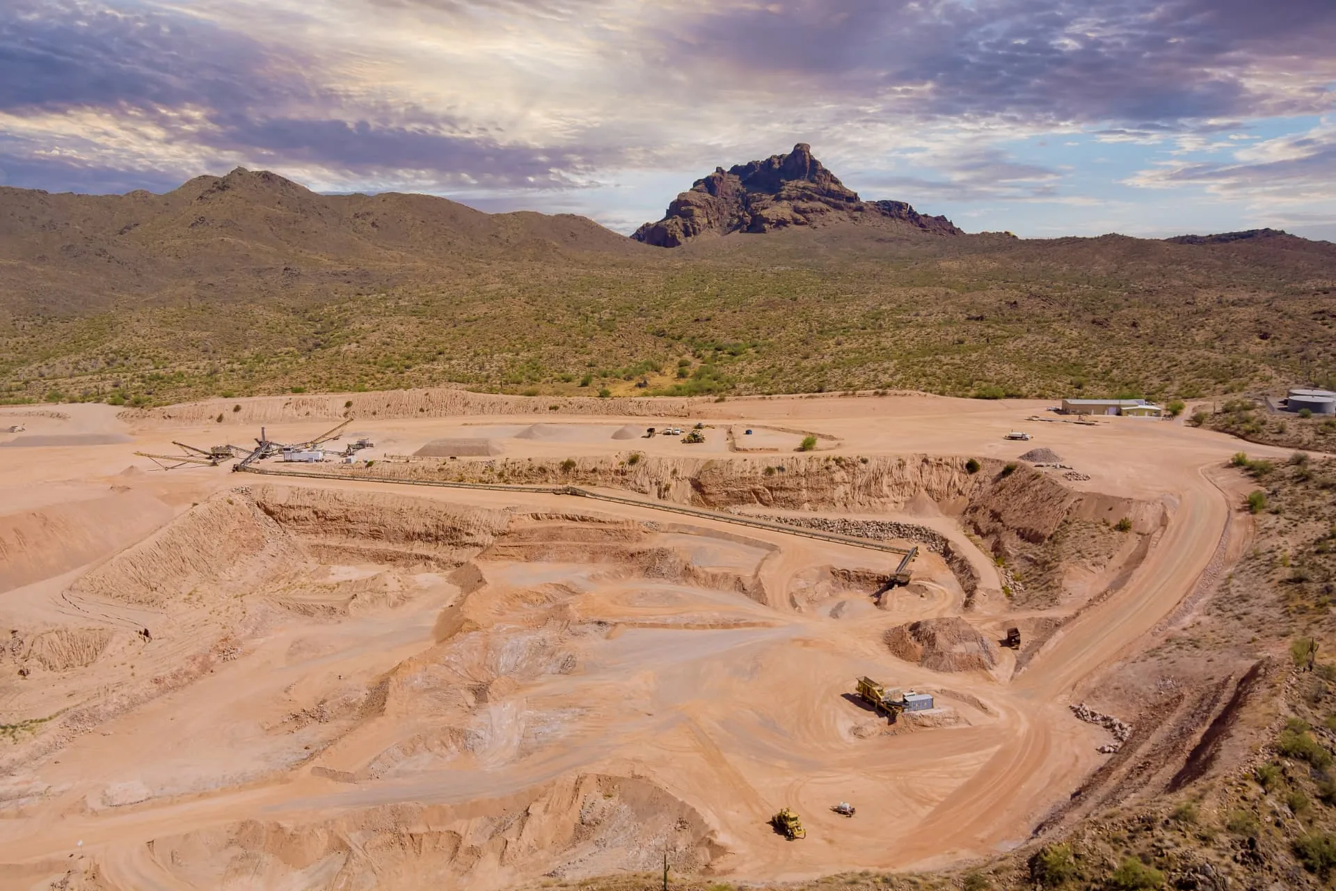Aerial view of benched quarry excavation below a saguaro covered mountain near Phoenix, AZ
