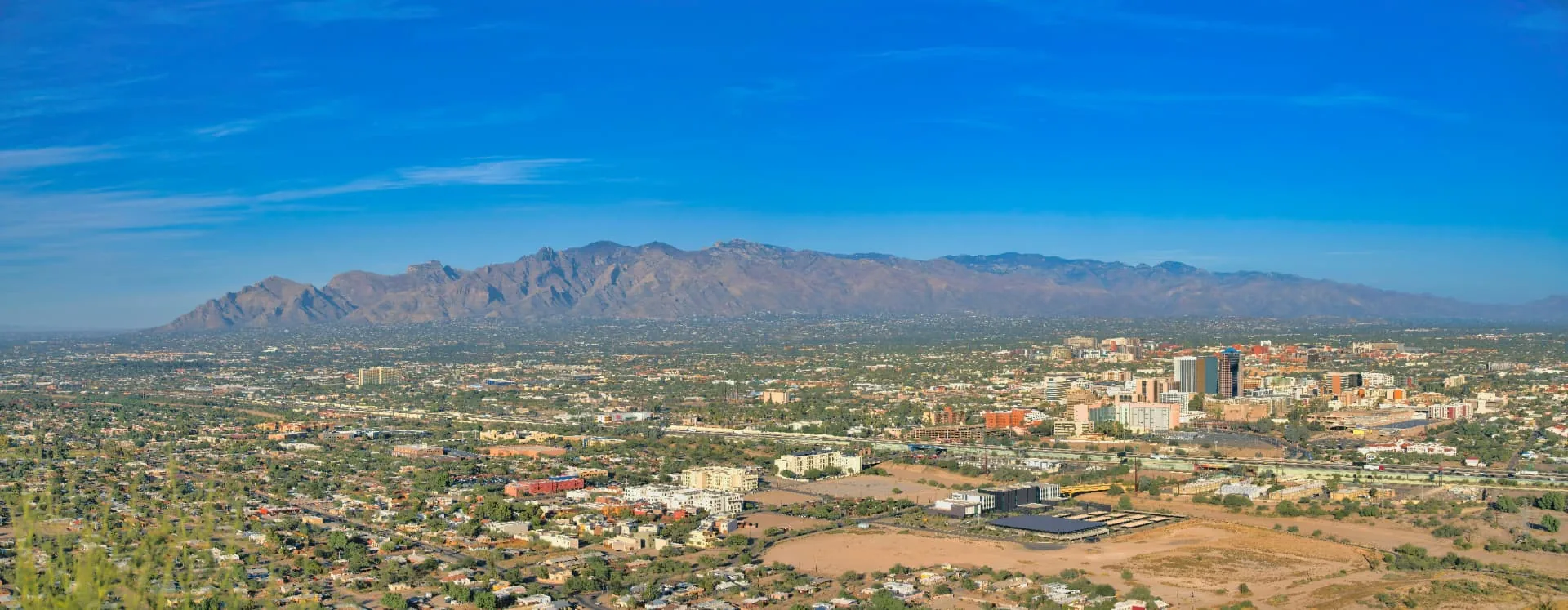 Downtown Phoenix, AZ skyline with South Mountain, home of Phoenician Excavation Company